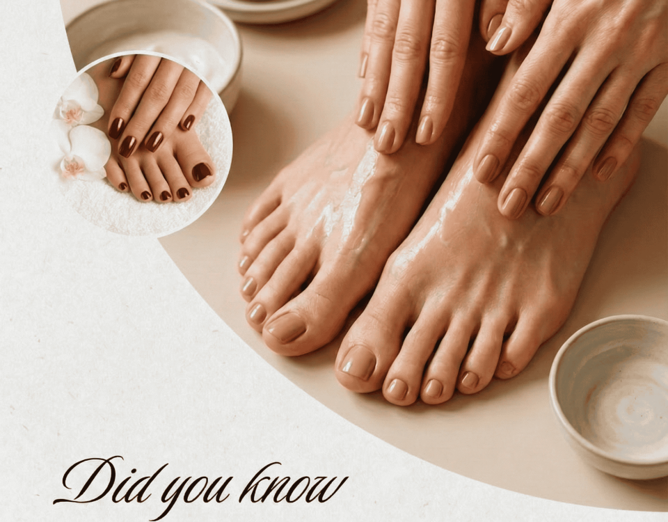 Hands exfoliating feet with scrub, showing red-polished nails.